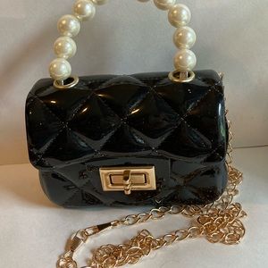 Mini quilted black jelly purse with pearl handle and gold crossover chain